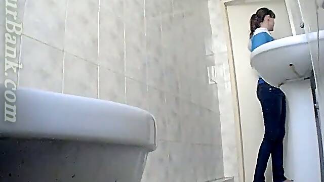 Blonde young babe in the toilet room filmed nude from behind